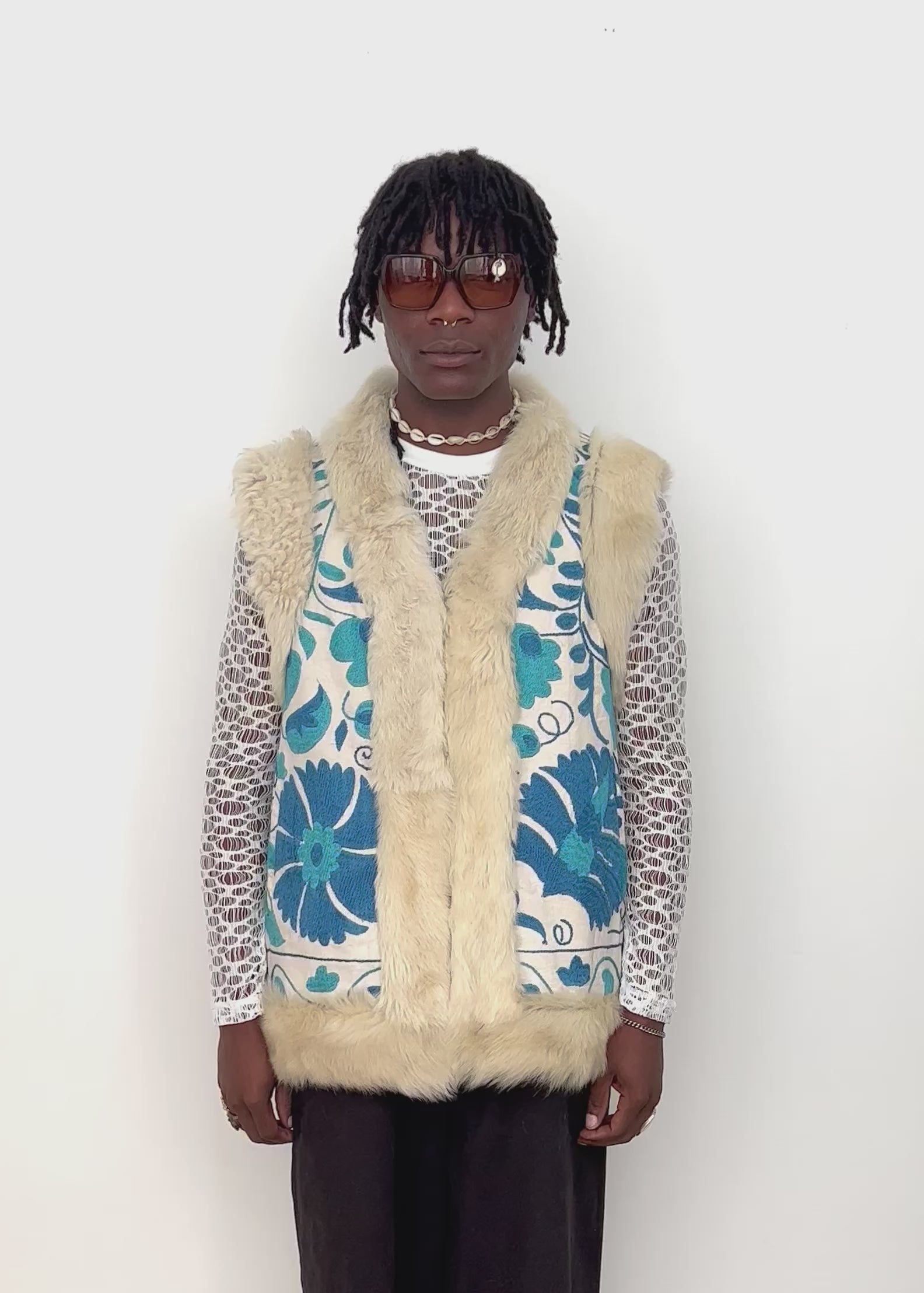 video of a model wearing 70's afghan suzani fur vest