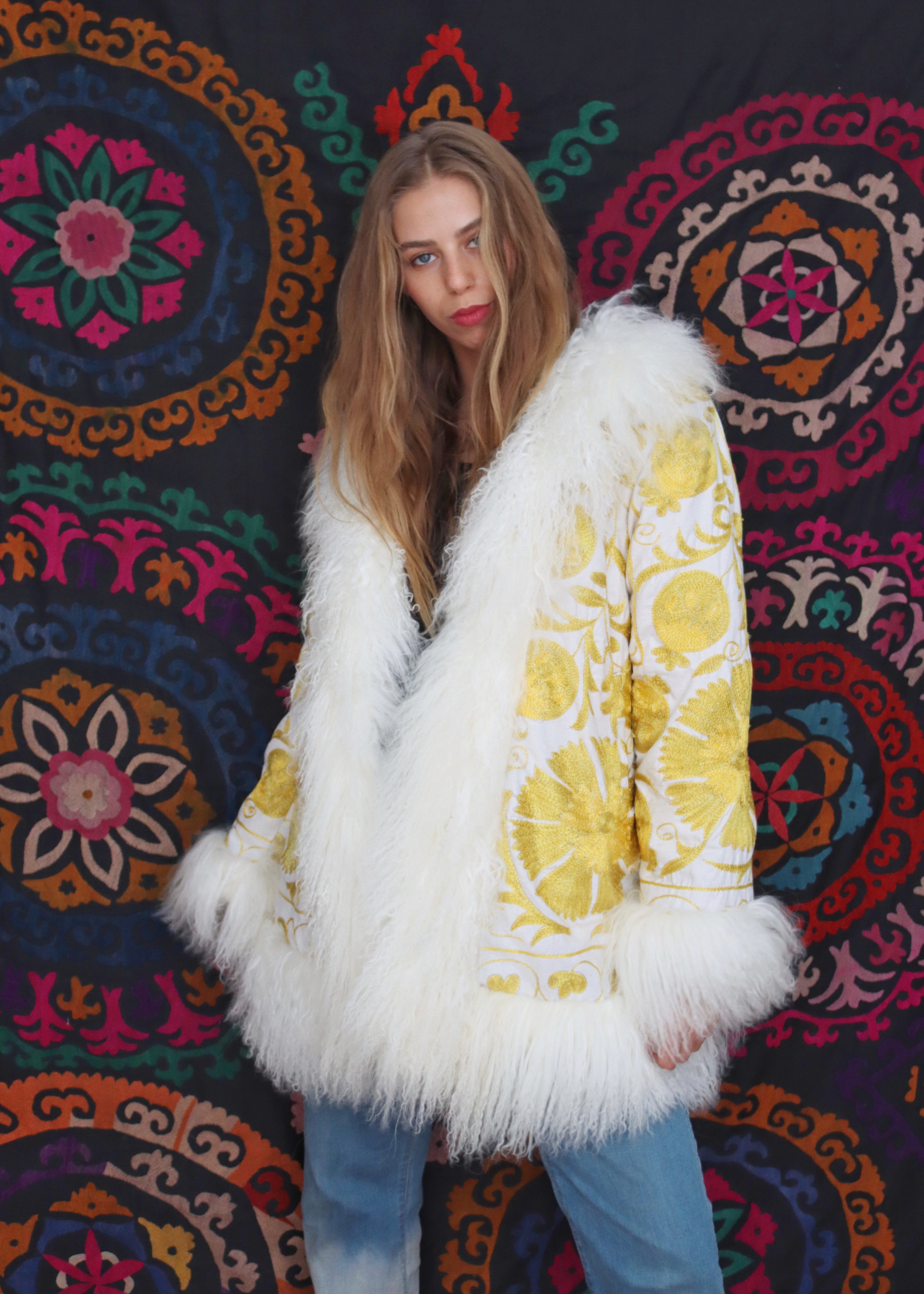 Model wearing vintage white and yellow suzani fur coat
