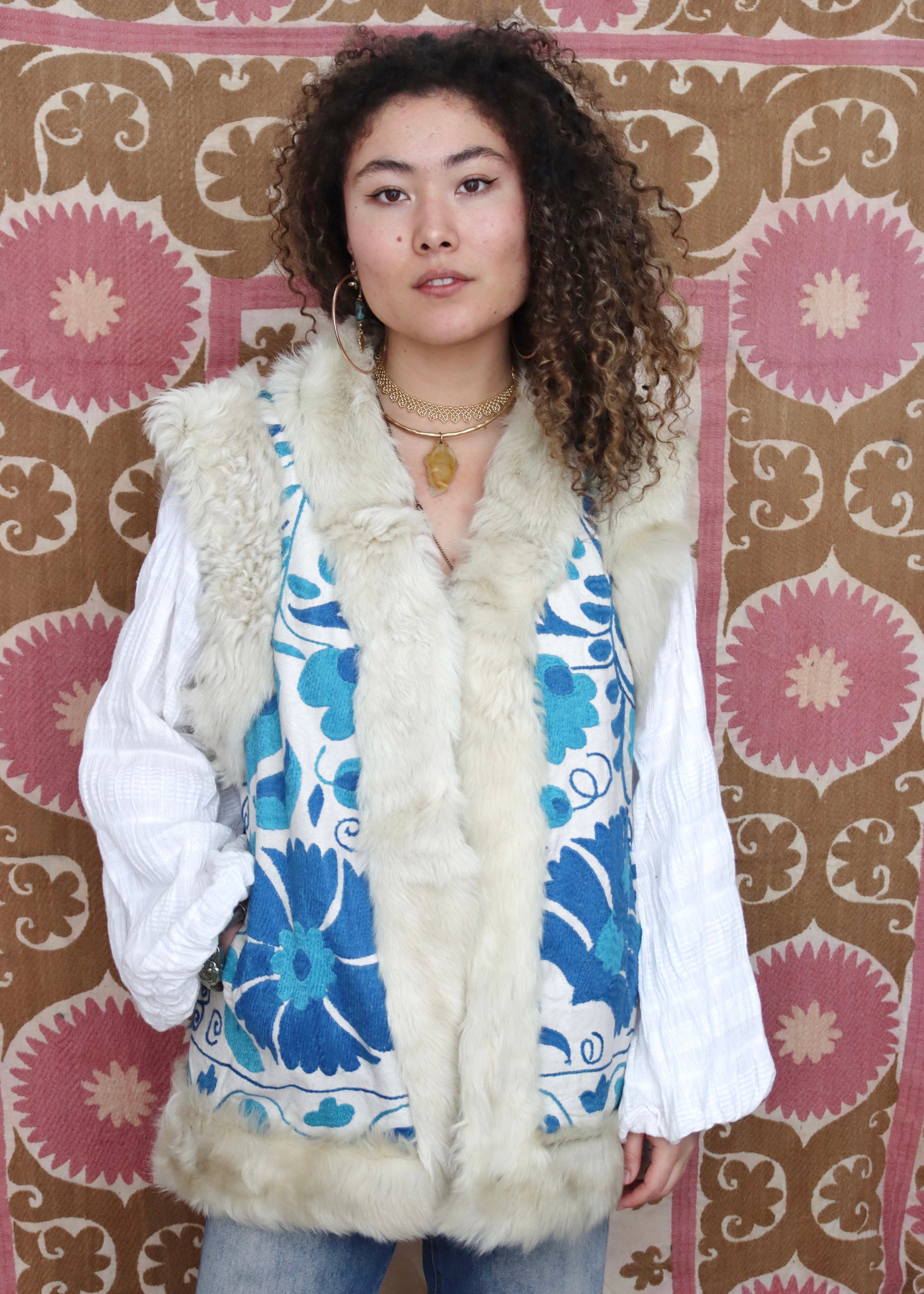 Model wearing vintage white and blue suzani fur vest